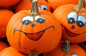 Pumpkins with crazy faces in a pumpkin patch